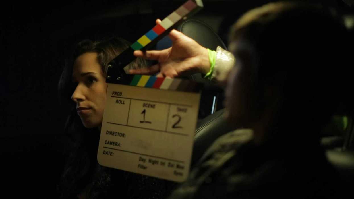 a clapboard open in front of an actor's face