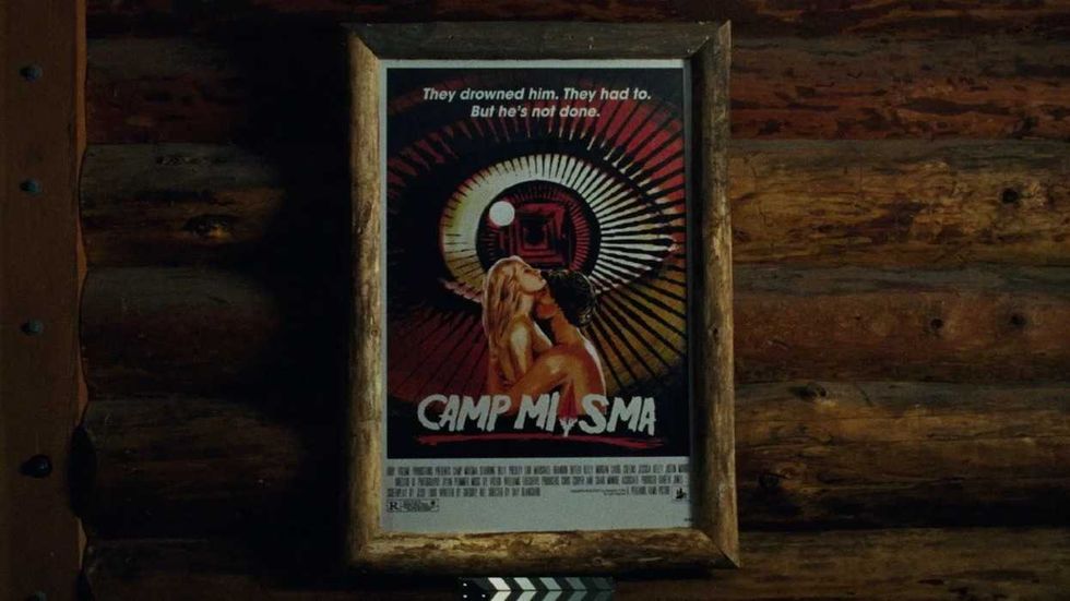 A close-up of a framed Camp Miasma poster in Teenage Sex and Death at Camp Miasma