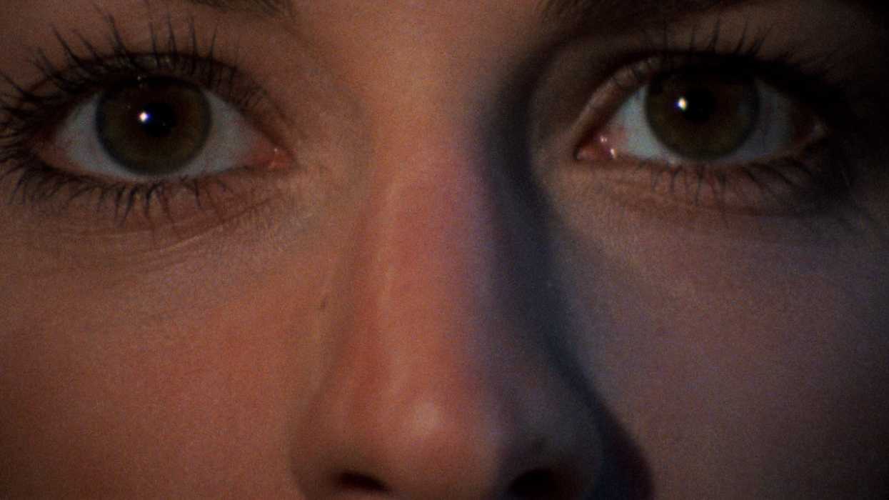 A closeup of a woman's eyes in The Evil Dead 1981