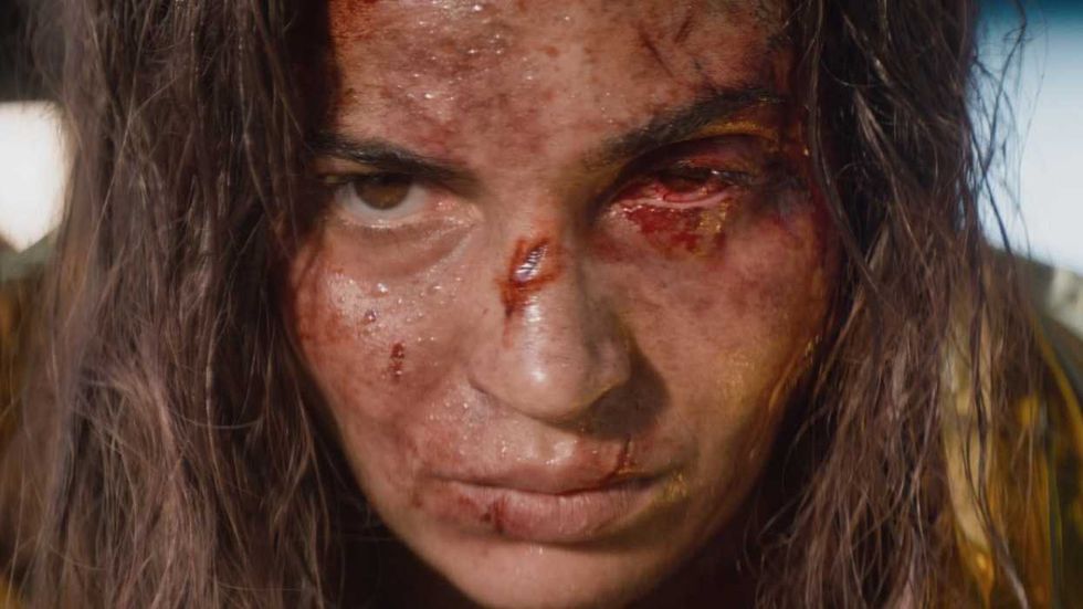 A closeup of Souheila Yacoub as Alice Price with a bloodied face in Evil Dead Burn