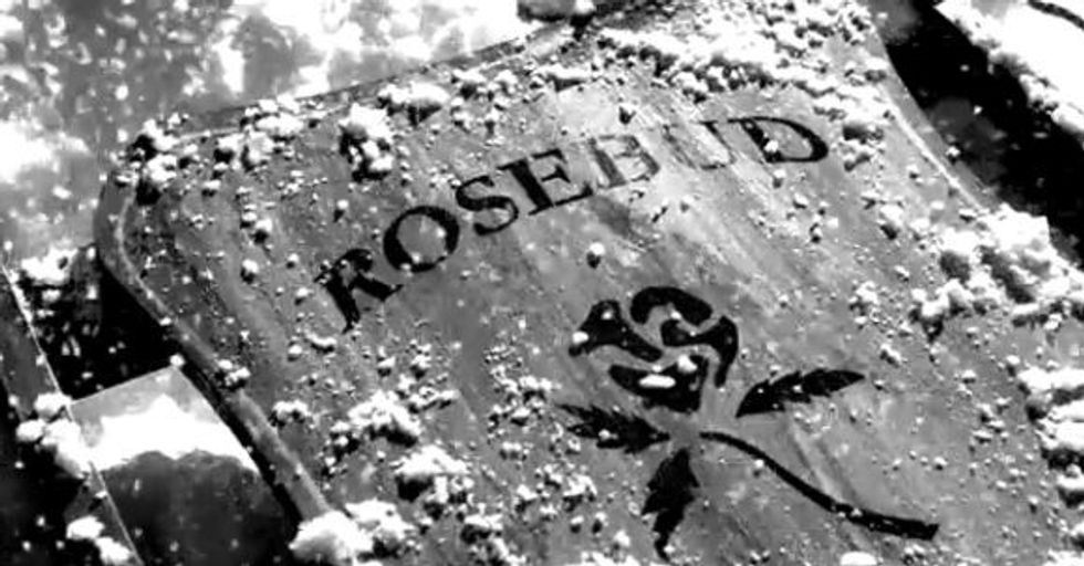 A closeup of the word rosebud and a rose painted on a sled in 'Citizen Kane'
