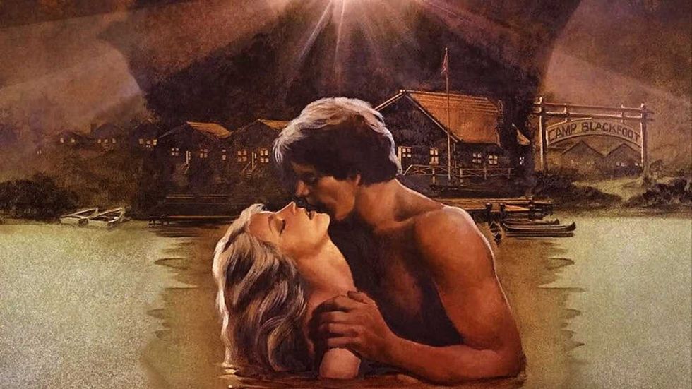 A couple kissing in a lake on the poster for The Burning
