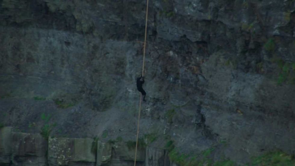 A figure climbing up the Cliffs of Insanity in The Princess Bride