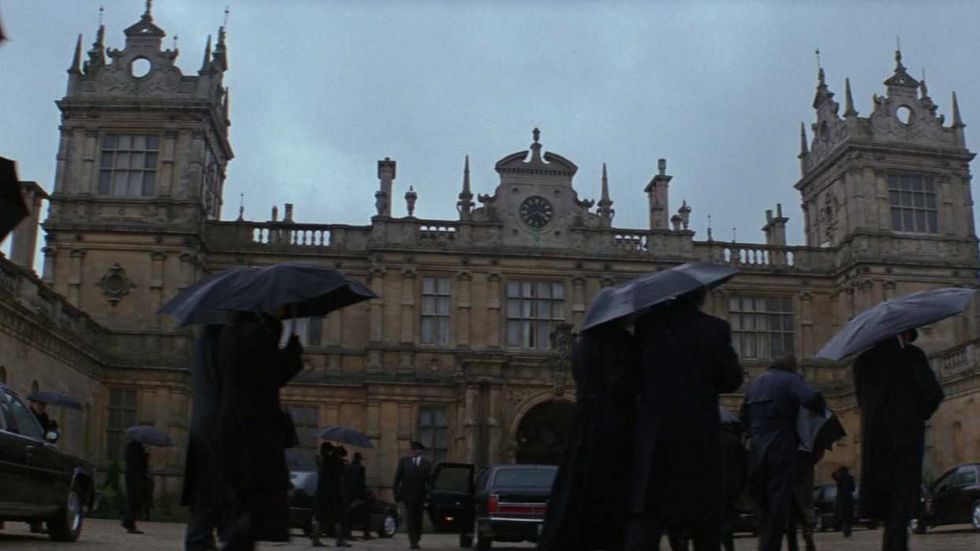 A funeral procession walks in front of Wayne Manor in Batman Begins Caption: \u2018Batman Begins\u2019 (2005)