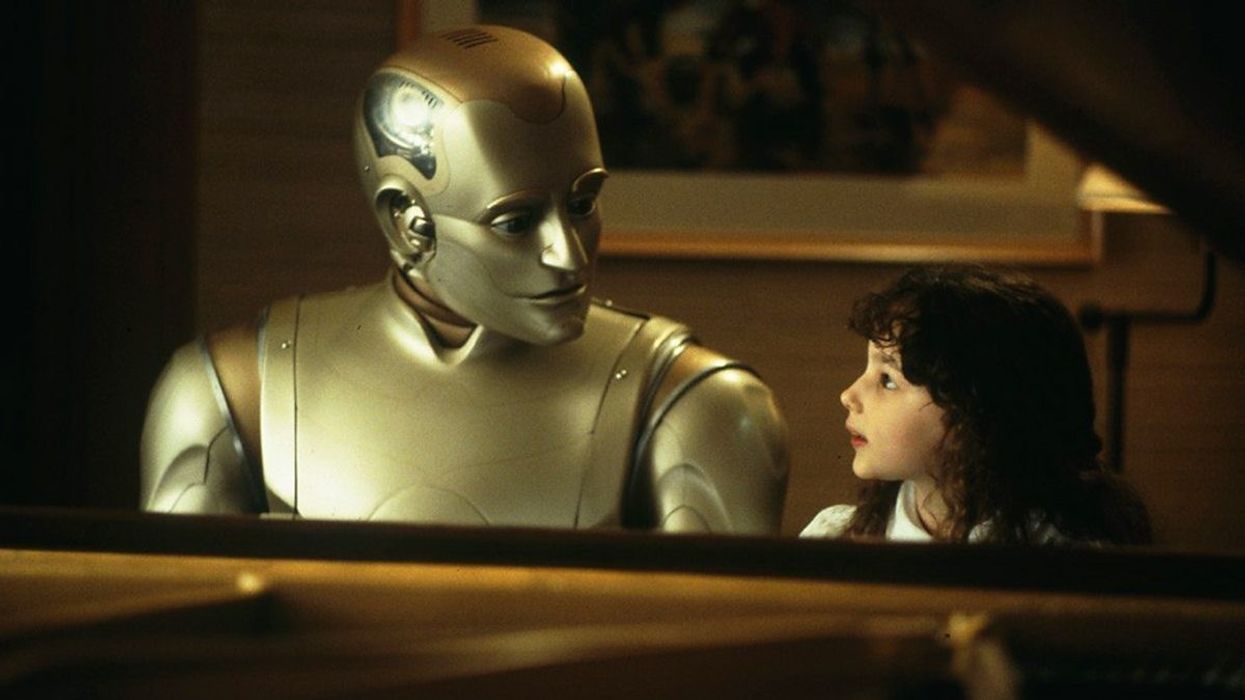 A golden robot sits with a child