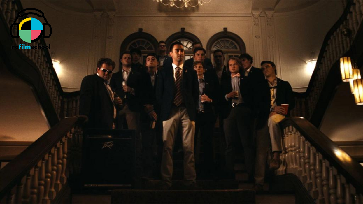A group of college men in suits on a stair case, 'The Line'