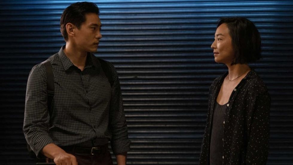 A man and a woman standing next to each on the sidewalk, 'Past Lives'