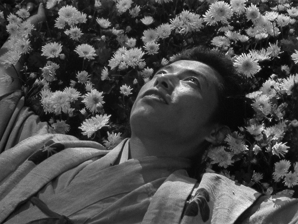 A man lays on flowers in 'Seven Samurai'