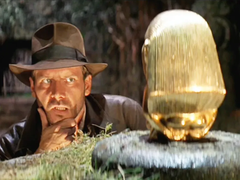 A man looking a gold statue, 'Raiders of the Lost Ark'