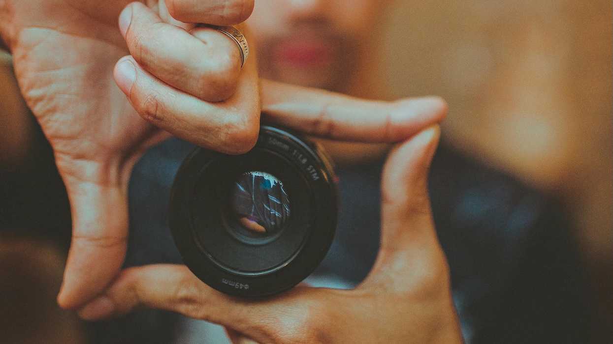 A Man Showing A Camera Lens