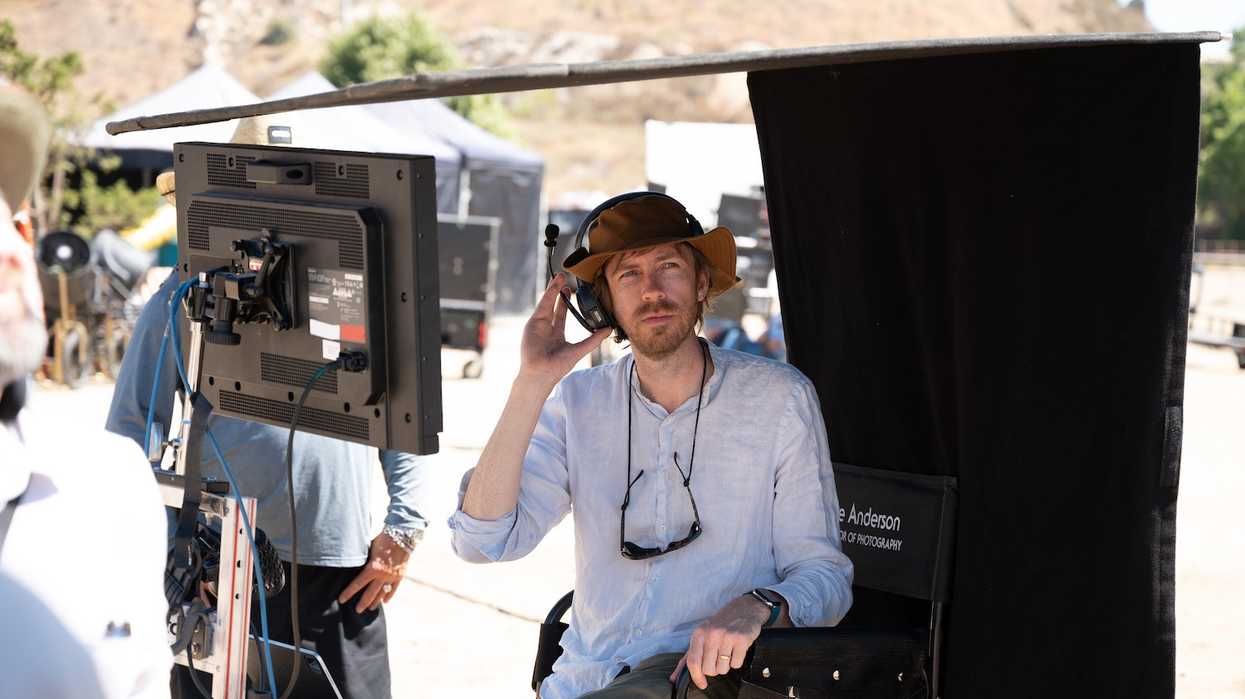 A man sits at a monitor in the desert, 'Mrs. Davis'