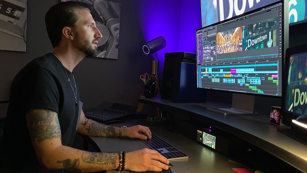 A man working on an editing softward program on his desktop.