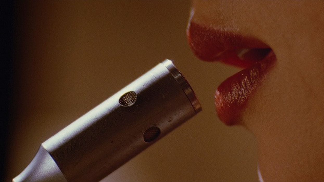 A pair of red lips speaking into a mircophone in 'Pulp Fiction'