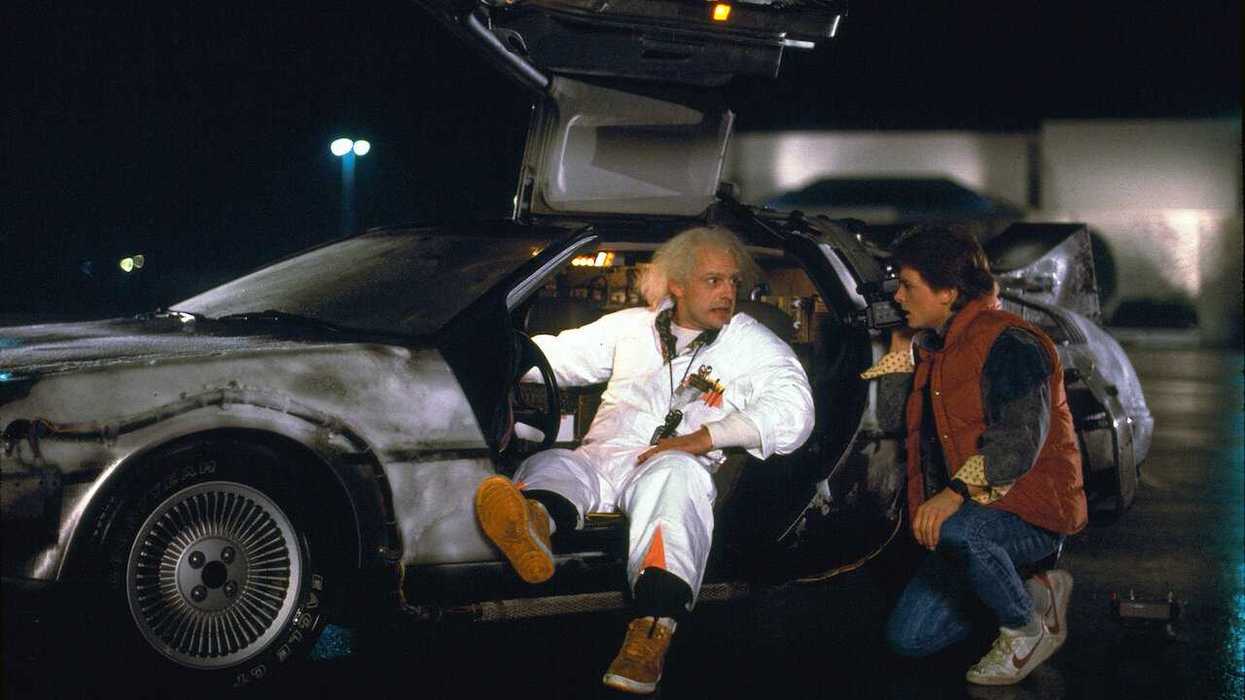 A pivotal moment from the 1985 film Back to the Future where Doc Brown (Christopher Lloyd) explains the DeLorean time machine to Marty McFly (Michael J. Fox).