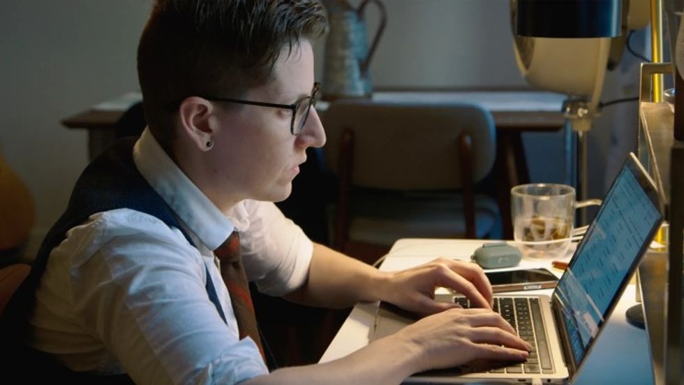 A reporter working on a laptop, 'Breaking the News'