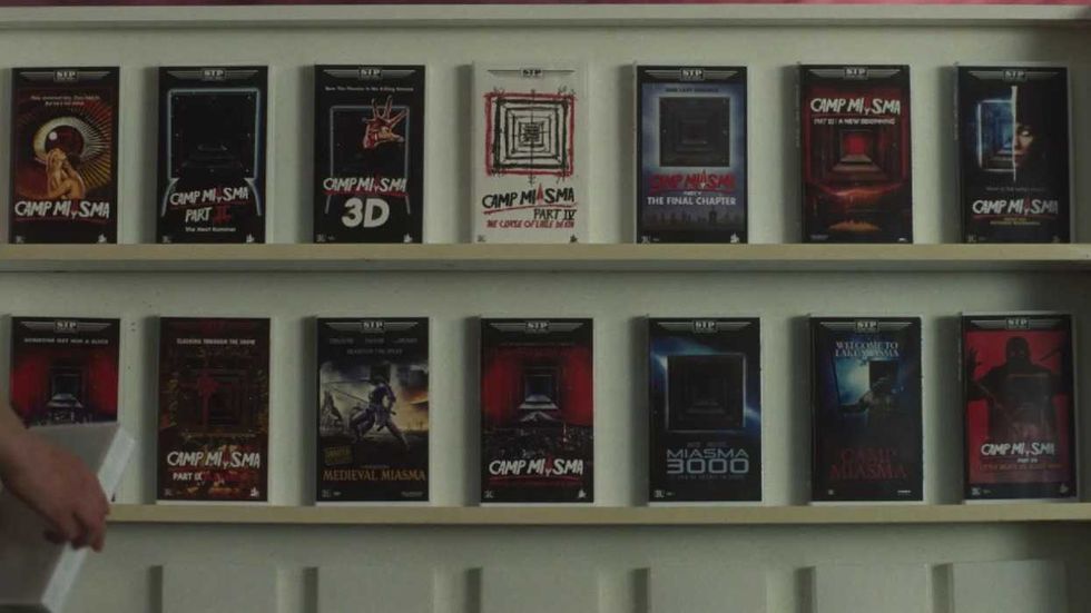 A shelf containing tapes of the Camp Miasma movies in Teenage Sex and Death at Camp Miasma