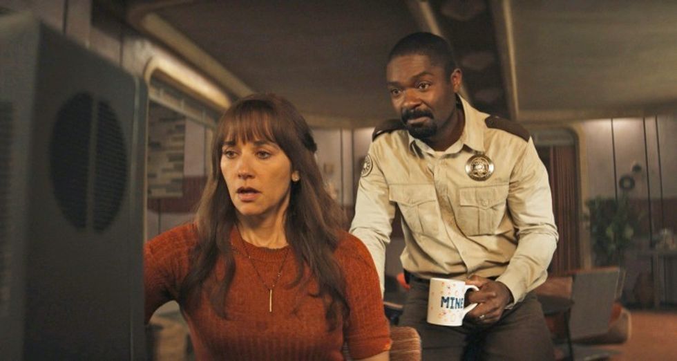 A woman and a man looking at a computer screen, 'Silo'