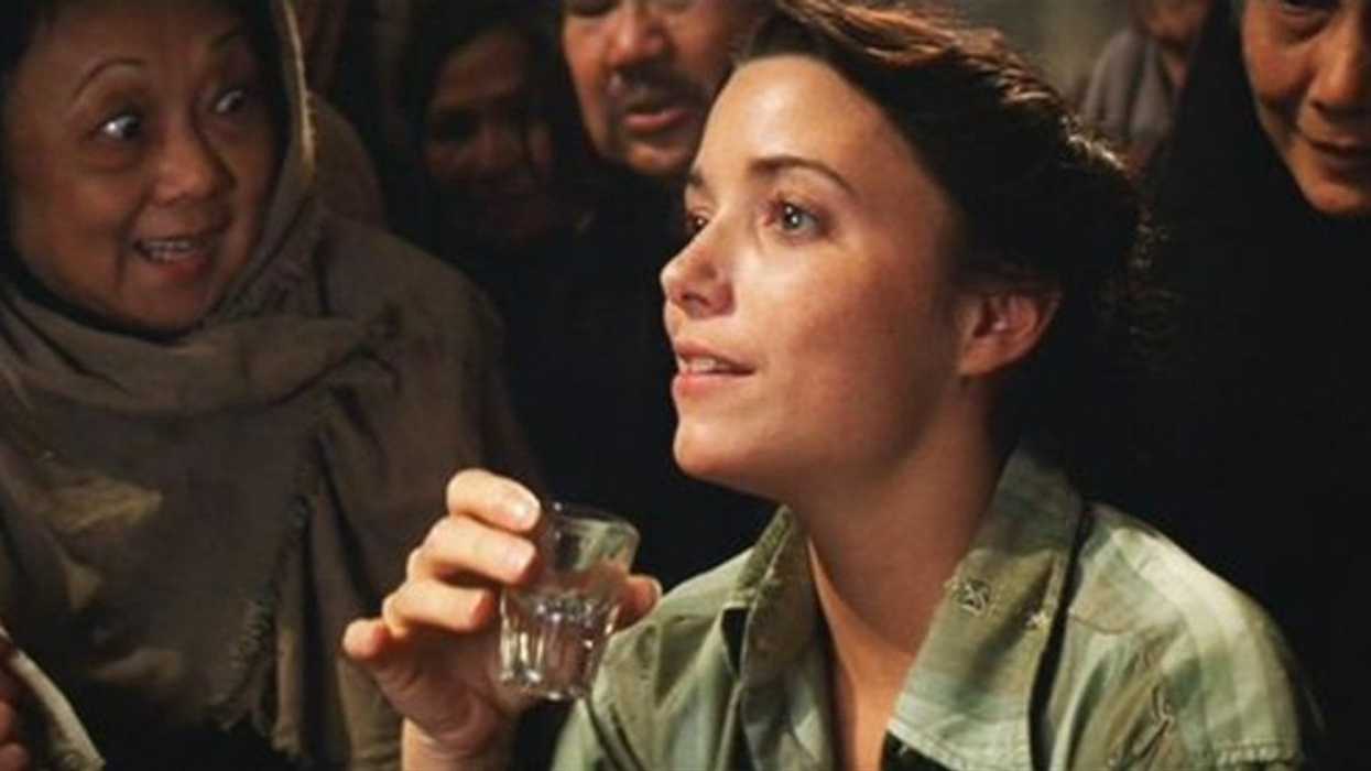 A woman drinking from a shot glass, 'Raiders of the Lost Ark'
