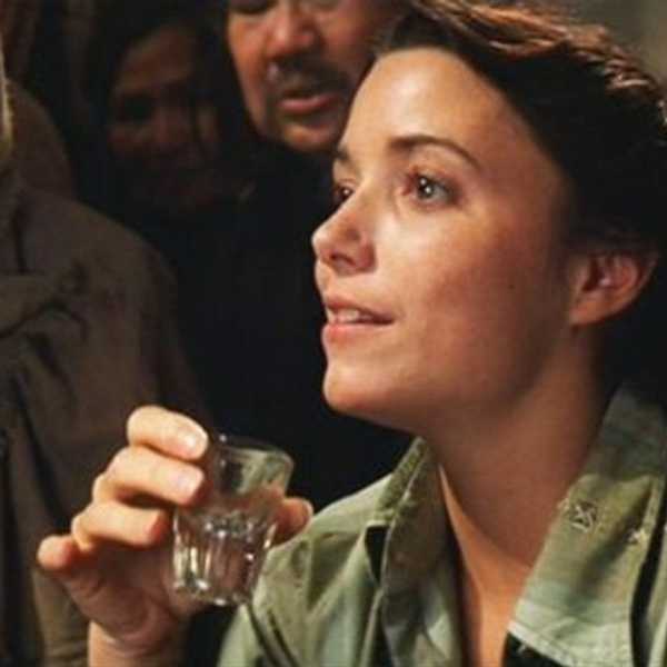 A woman drinking from a shot glass, 'Raiders of the Lost Ark'
