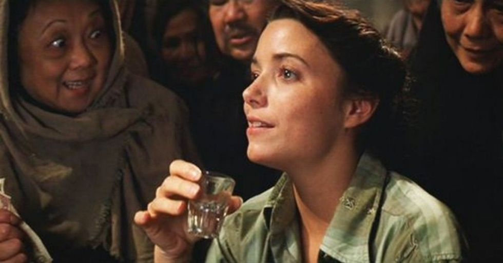 A woman drinking from a shot glass, 'Raiders of the Lost Ark'