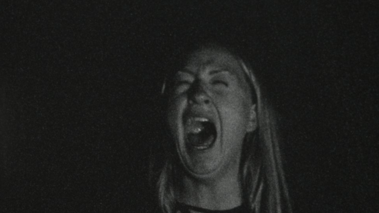 A woman screaming in a black and white still from '*666'