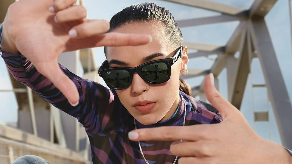 A woman wears black Ray-Ban smart glasses