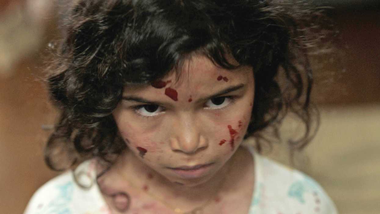 A young girl with blood on her face in 'Birth/Rebirth'