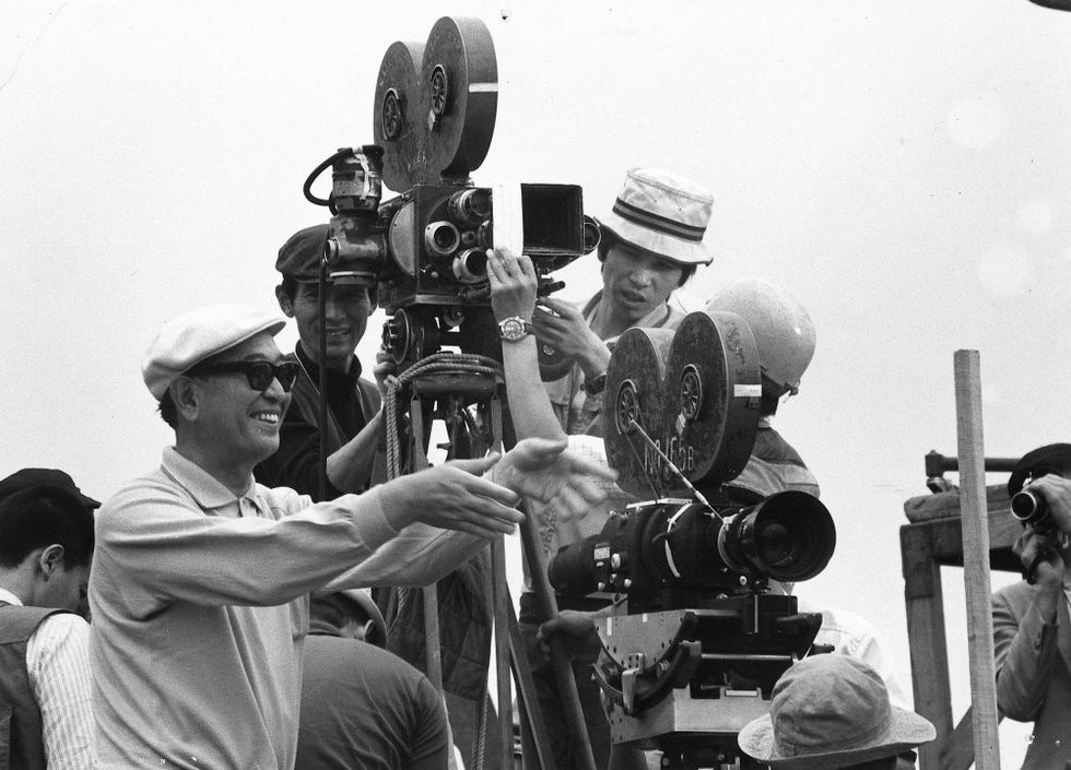 Akira Kurosawa working with a cinema camera on the set of