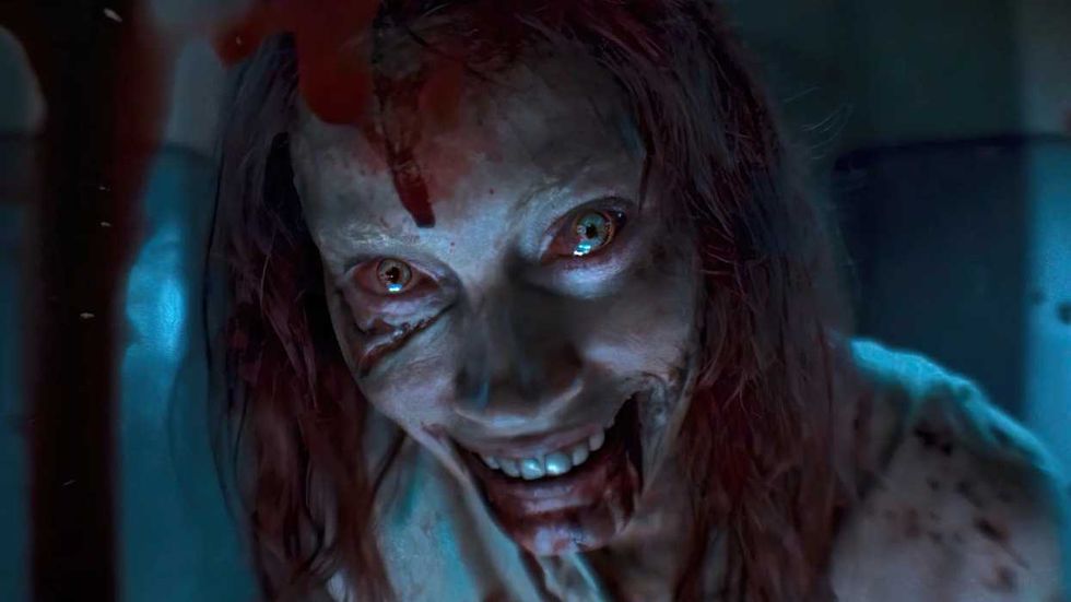 Alyssa Sutherland as Deadite Ellie peering through a peephole in Evil Dead Rise