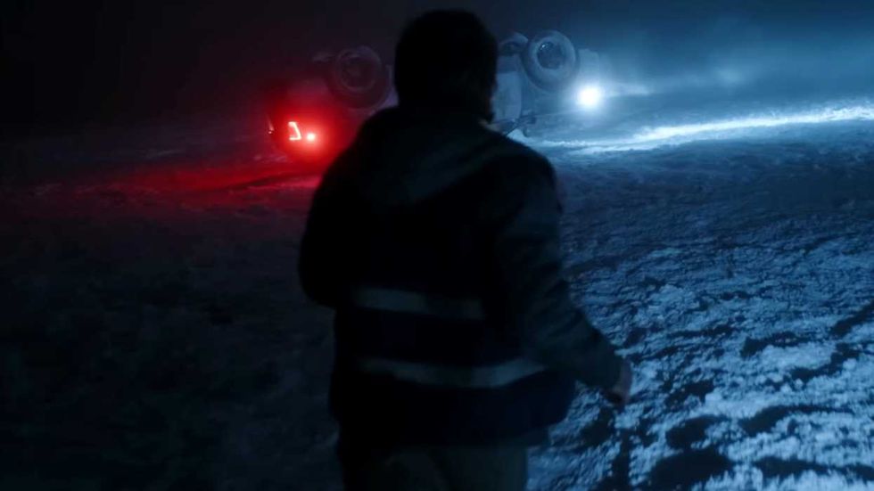 Austin Abrams as Bryan running toward an overturned car in Resident Evil 2026
