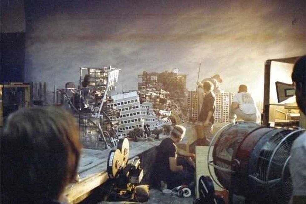 Behind-the-scenes crew members building and setting up the Judgment Day nuclear nightmare miniature model for the 1991 film Terminator 2: Judgment Da