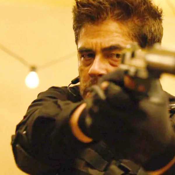 Benicio Del Toro as Alejandro holding a man at gunpoint in Sicario