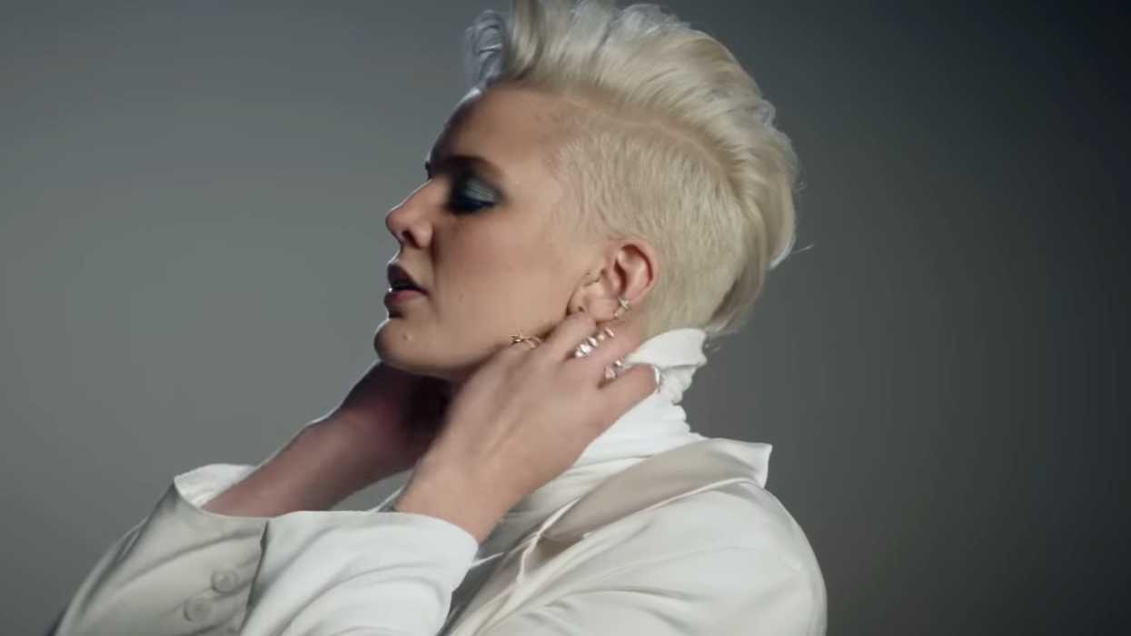 Betty Who adjusting a turtleneck in the Ignore Me music video