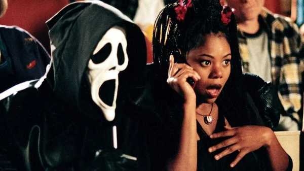 Brenda and Ghostface sitting in the movie theater in Scary Movie