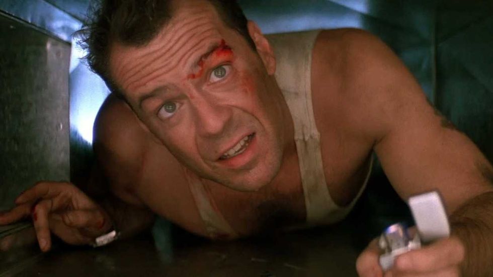 Bruce Willis crawling through an air vent in Die Hard