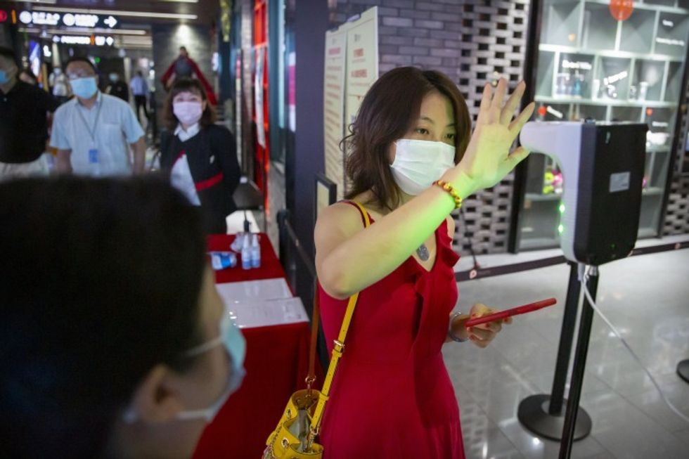 Chinese-movie-theater-patron-at-temperature-scanner