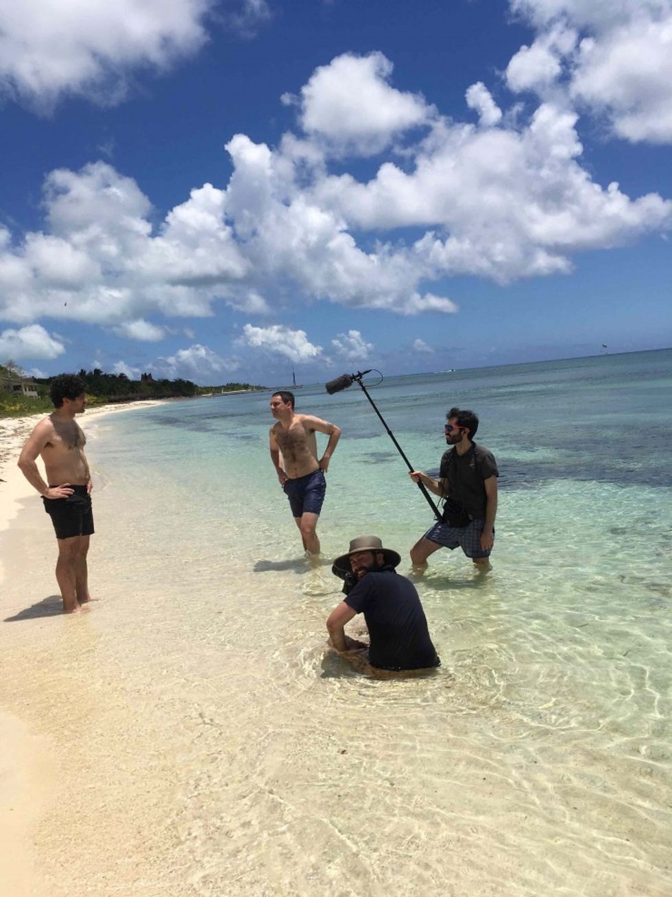 Chris Roberti, Jeff Seal, Darin Quan, and Josh Itzkowitz filming in clear blue water