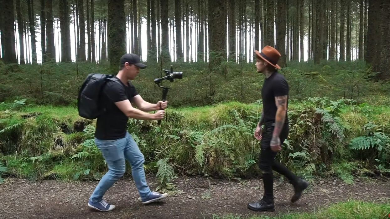Cinematographer does the gimbal reverse follow on a subject.