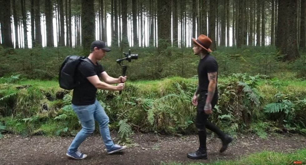 Cinematographer does the gimbal reverse follow on a subject.