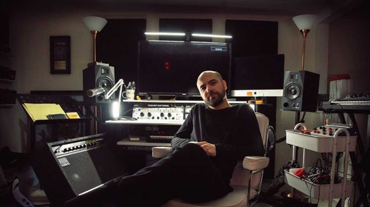 Composer Andrew Gordon Macpherson sitting in a recording booth.