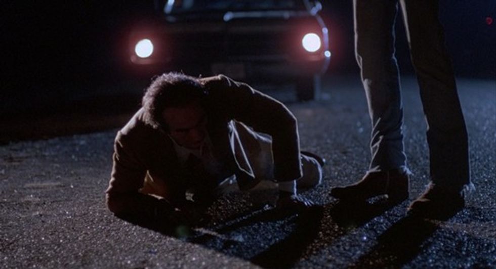 Dan Hedaya as Julian Marty crawling in front of a car in 'Blood Simple'