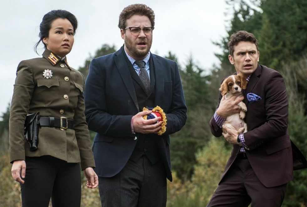  Dave Skylark, played by James Franco, and Aaron Rapaport, played by Seth Rogen, standing with a general and a dog in 'The Interview'