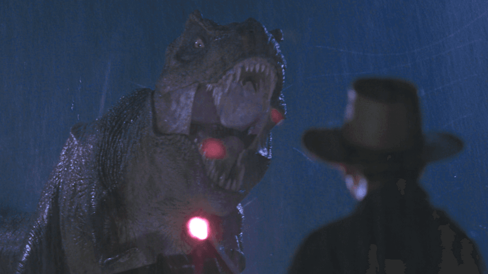 Dr. Alan Grant using a glowing flare to distract the escaped Tyrannosaurus Rex from Steven Spielberg's Jurassic Park (1993)