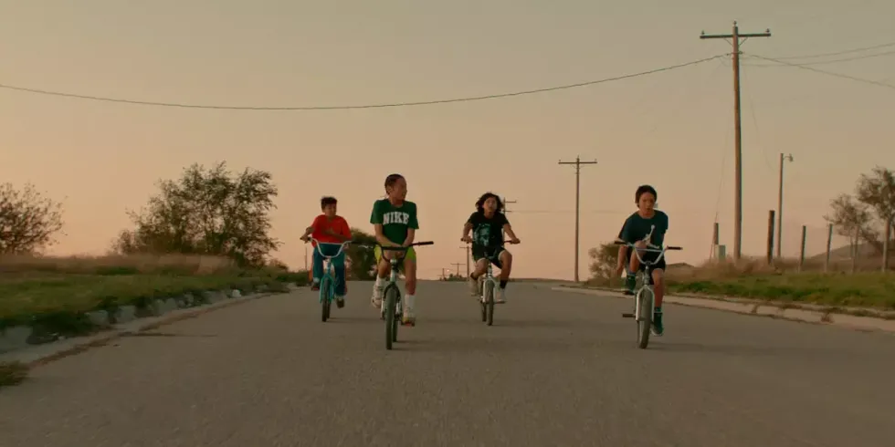 Four boys riding bikes at sunset in 'War Pony'