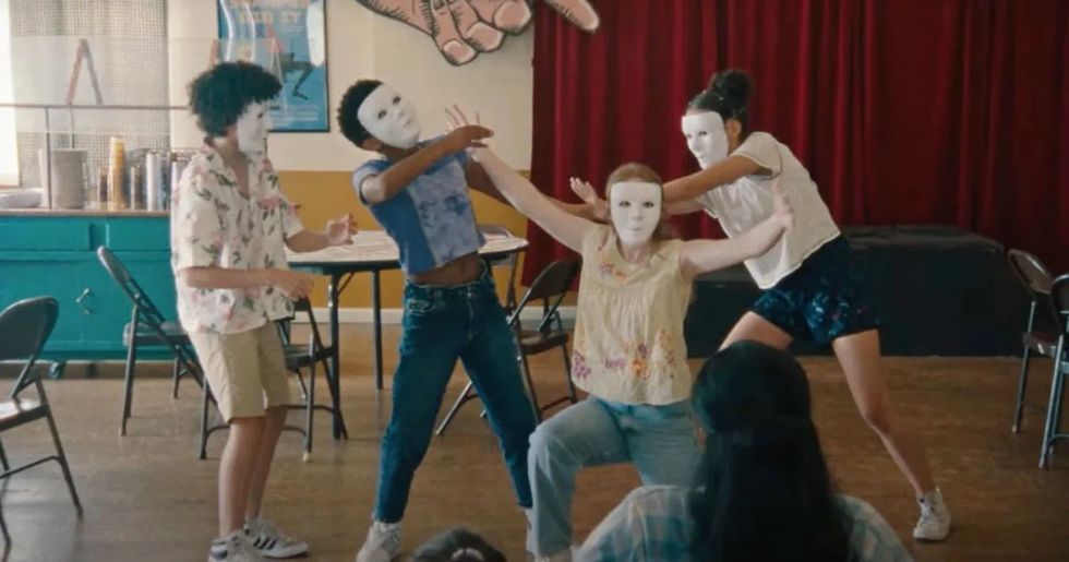 Four children acting in white mask