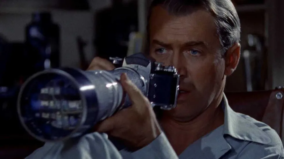 James Stewart as Jeff using a telephoto lens in Rear Window