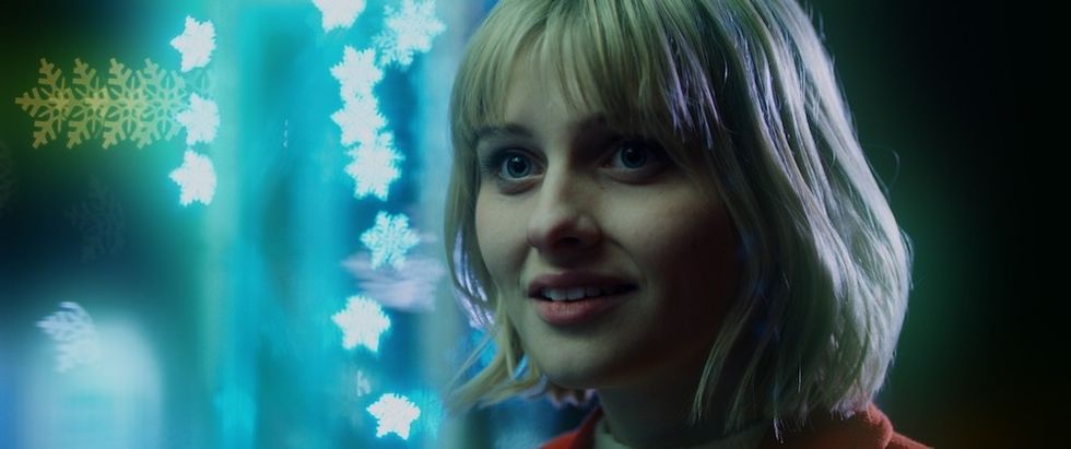Jane Widdop smiling with holiday lights