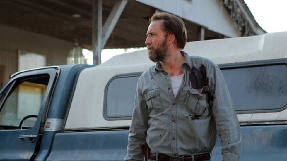 Joe Ransom, played by Nicolas Cage, in front of a blue pickup truck, 'Joe'