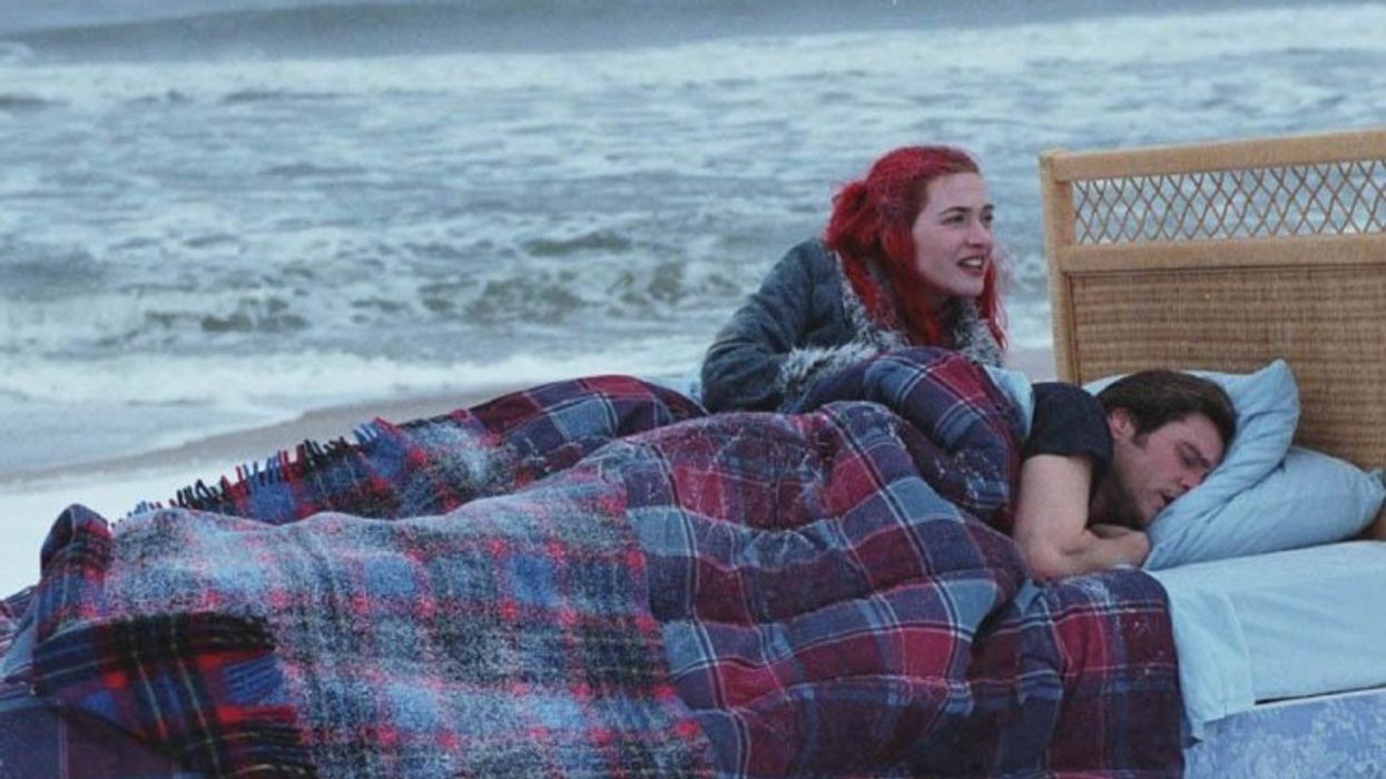 Joel Barish, played by Jim Carrey, and Clementine Kruczynski, played by Kate Winslet, in a bed on the beach in 'Enternal Sunshine of the Spotless Mind'