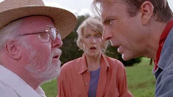 John Hammond and Alan Grant staring each other down while Ellie Sattler looks on in Jurassic Park